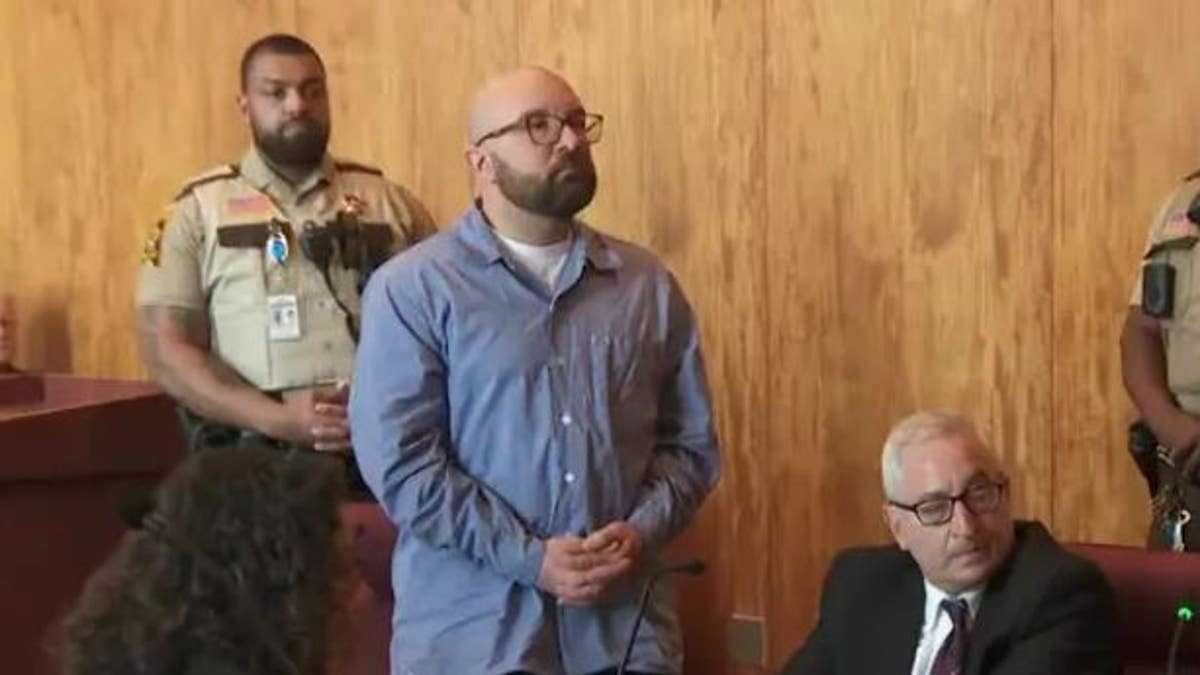 Nicholas Firkus standing in court