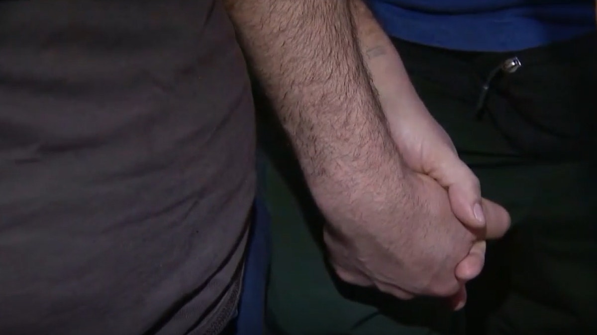Couple holding hands