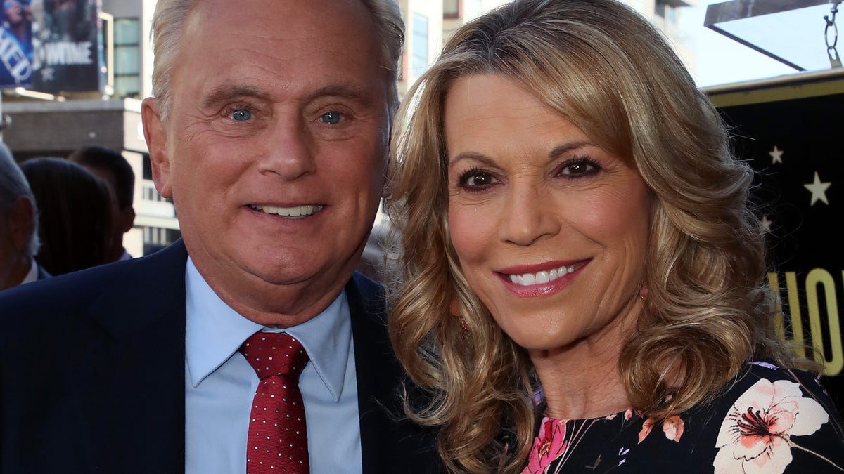 Pat Sajak and Vanna White post for a photo together on the Hollywood Walk of Fame