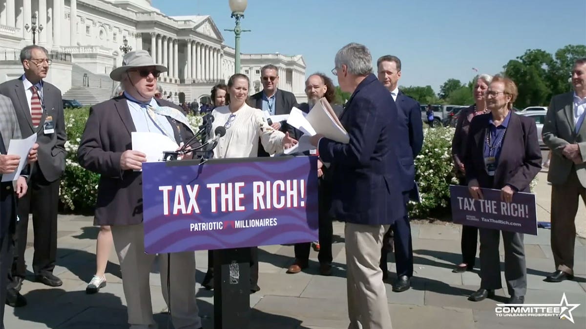 Stephen Moore hands out petitions during Patriotic Millionares conference