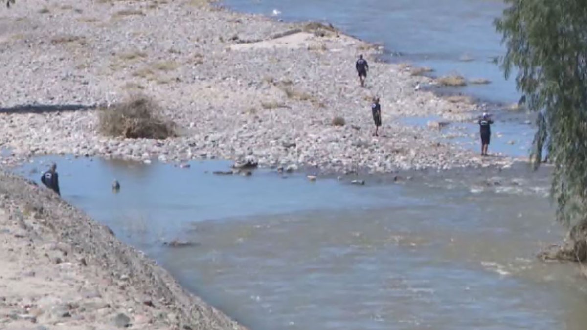 rescuers searching the river banks