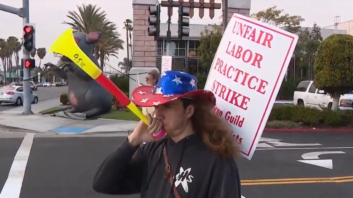 Striking Medieval Times worker blows horn