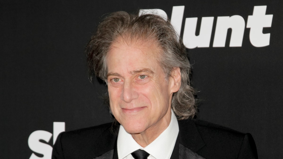 Richard Lewis poses at a movie premiere.
