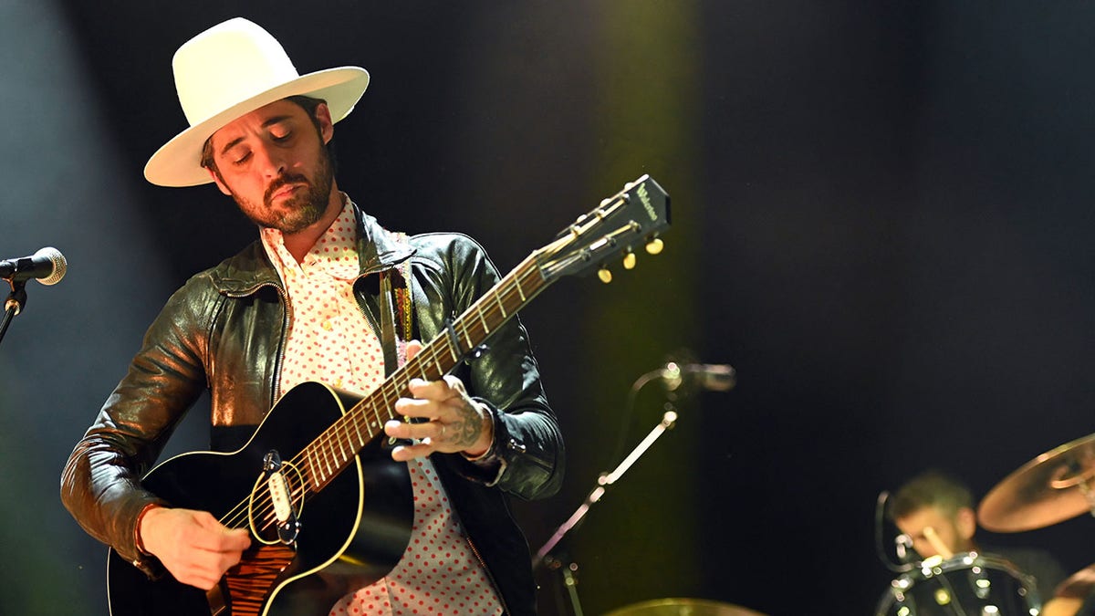 Ryan Bingham playing the guitar