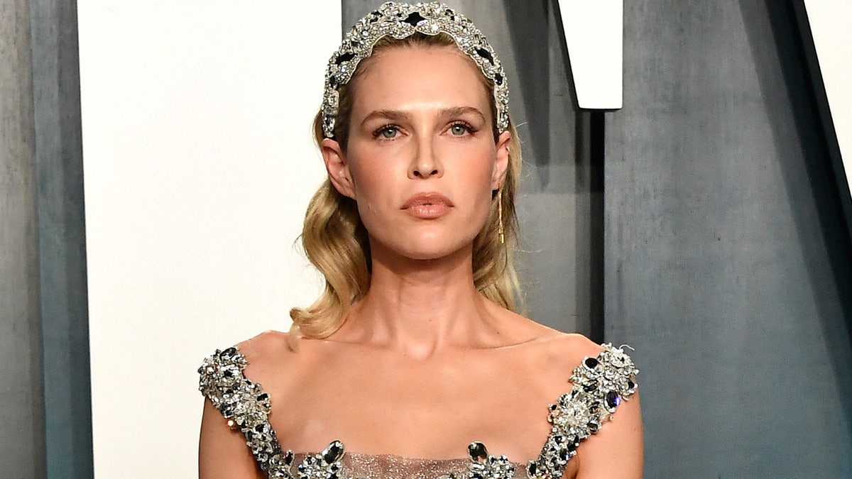Sara Foster walks red carpet at Vanity Fair Oscars party wearing silver sparkling gown with diamonds