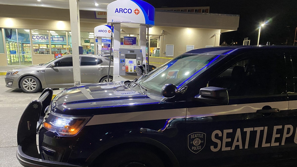 Seattle police car outside gas station convenience store