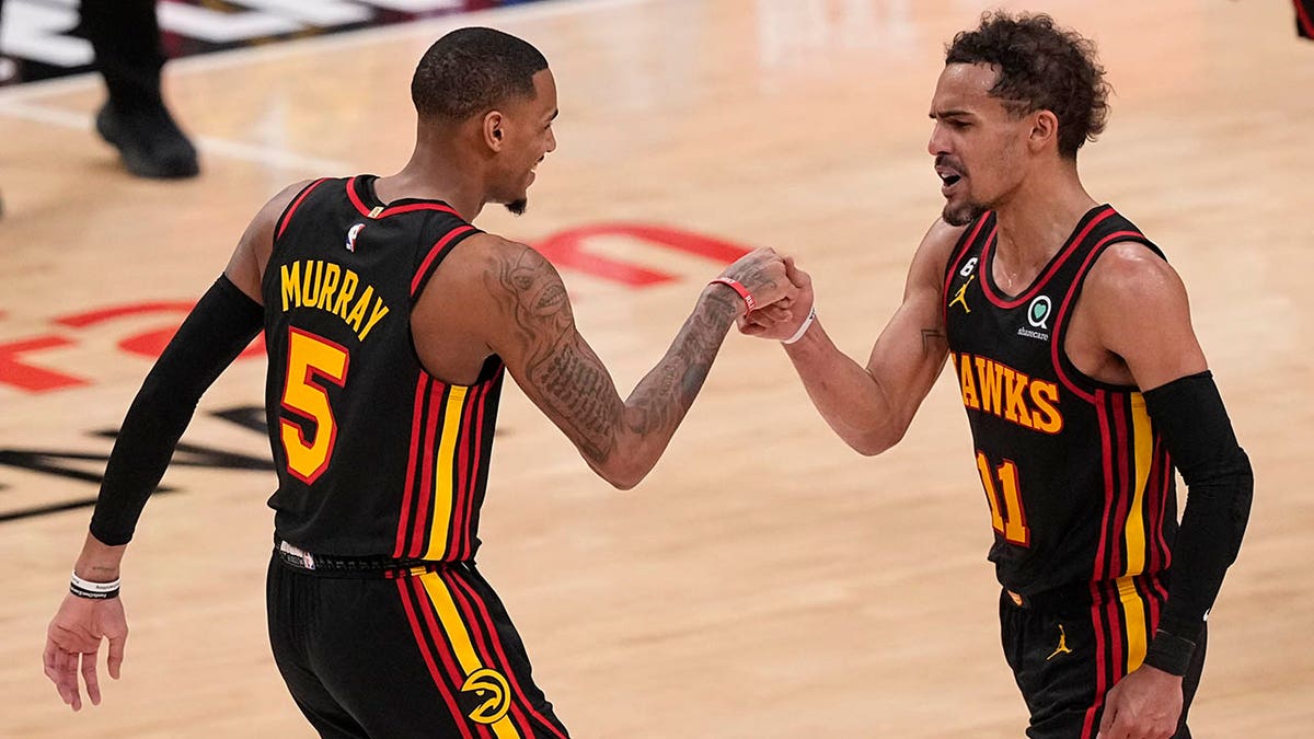 Dejounte Murray and Trae Young fist bump