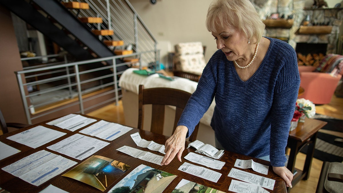 Vicki Baker looks at photos of the damage to her McKinney, Texas home.