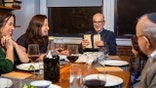 A modern Jewish American family celebrates Passover together. The Seder leader breaks the middle matzo (Yachatz).