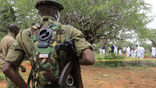 Kenya police officers stand guard as Forensic experts and homicide detectives exhume bodies of suspected members of a Christian cult named as Good News International Church, who believed they would go to heaven if they starved themselves to death, in Shakahola forest of Kilifi county, Kenya April 22, 2023. REUTERS/Stringer