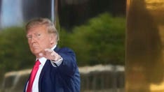 New Yorkers in front of Trump Tower clash over former president's odds of a fair trial ahead of arraignment