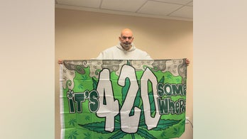 Sen. Fetterman tweets image holding 420 flag to acknowledge cannabis holiday