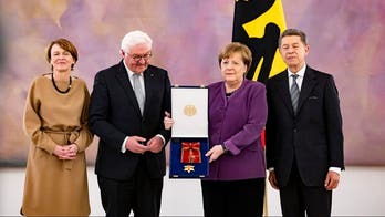 Germany's Angela Merkel receives nation's highest honor, despite head-scratching in her own party