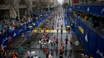 Boston Marathon runner appears to take bathroom break on someone's front lawn