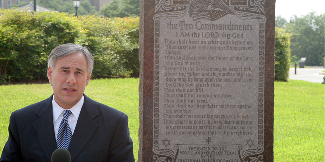 Gov. Abbott next to 10 Commandments plaque