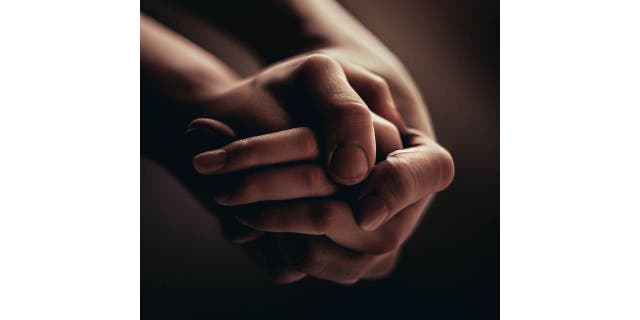 two hands clasped together