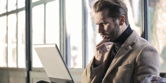 Man looks stressed while at his computer