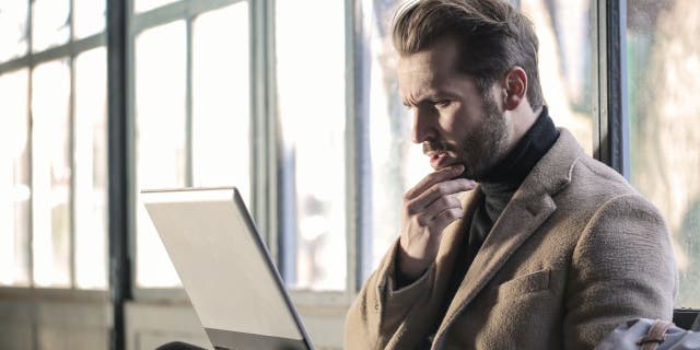 Man looks stressed while at his computer