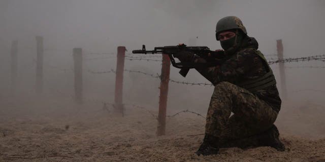 A Ukrainian soldier takes part in a military drill on psychological combat training at an undisclosed location close to the border with Belarus, in Ukraine, March 11, 2023.