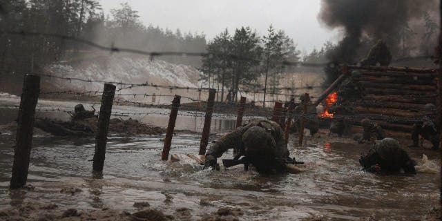 Ukrainian soldiers from various brigades take part in a military drill on psychological combat training at an undisclosed location close to the border with Belarus.