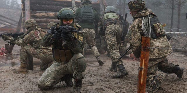 Ukrainian soldiers from various brigades take part in a military drill on psychological combat training at an undisclosed location close to the border with Belarus in Ukraine March 11, 2023. 