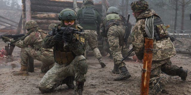 Ukrainian soldiers from various brigades take part in a military drill on psychological combat training at an undisclosed location close to the border with Belarus in Ukraine March 11, 2023.
