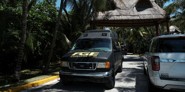 Police respond to the Fiesta Americana hotel in Cancun on Monday after four men were gunned down in an apparent drug-related incident.