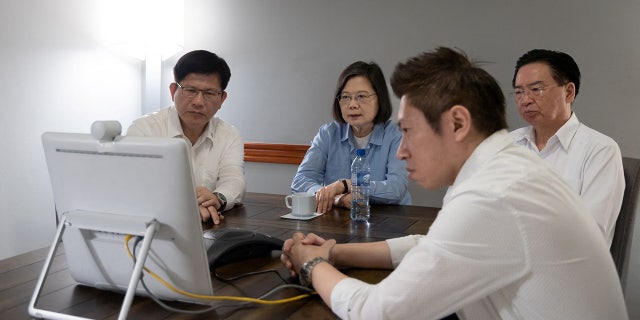 Taiwanese President Tsai Ing-wen attends a video call with senior members of government and security officials in Taipei, during her trip to Belize.
