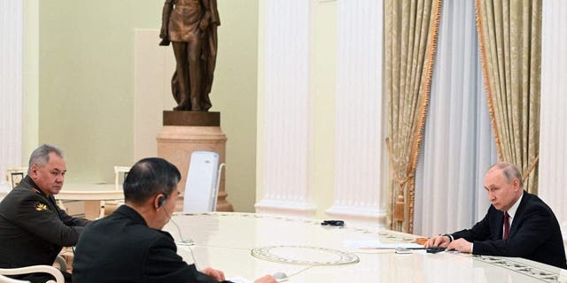 Russian President Vladimir Putin, right, and Russian Defense Minister Sergei Shoigu, left, meet with Chinese Defense Minister Li Shangfu at the Kremlin in Moscow on April 16, 2023.