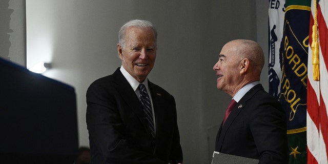 President Joe Biden seen greeting Homeland Security Secretary (DHS) Alejandro Mayorkas. The DHS adjusted its policy that immigrants can now select a gender marker on benefits applications that does not match other documentation. 