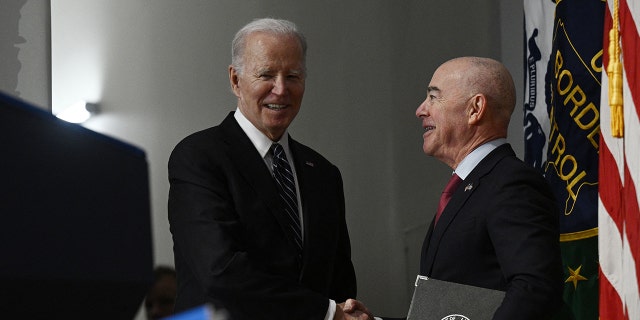 President Joe Biden seen greeting Homeland Security Secretary (DHS) Alejandro Mayorkas. The DHS adjusted its policy that immigrants can now select a gender marker on benefits applications that does not match other documentation.