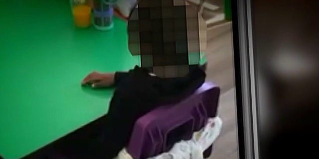 Screenshot of the video showing 2-year-old Sean Campbell tied to a chair during a birthday party at his daycare in Maryland.