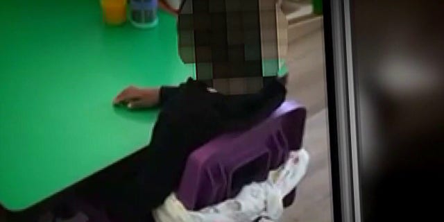 Screenshot of the video showing 2-year-old Sean Campbell tied to a chair during a birthday party at his daycare in Maryland.