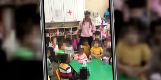 Teachers and children participate in a daycare birthday party in Germantown, Maryland.