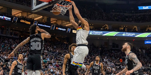 Minnesota Timberwolves center Rudy Gobert dunks over San Antonio Spurs forward Julian Champagnie, Saturday, April 8, 2023, in Austin, Texas.