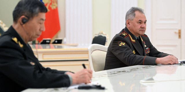 Russian Defense Minister Sergei Shoigu, right, attends a meeting of Russian President Vladimir Putin and Chinese Defense Minister Gen. Li Shangfu, left, at the Kremlin in Moscow, on April 16, 2023.