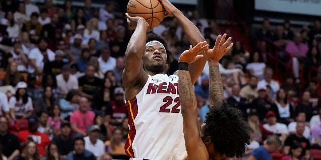 Miami Heat forward Jimmy Butler, #22, shoots over Chicago Bulls guard Coby White, #0, during the first half of an NBA basketball play-in tournament game, Friday, April 14, 2023, in Miami.
