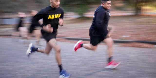 Army Staff Sgt. Daniel Murillo, right, runs up a hill as part of his physical training at Ft. Bragg on Jan. 18, 2023, in Fayetteville, North Carolina. Obesity in the military surged during the pandemic.