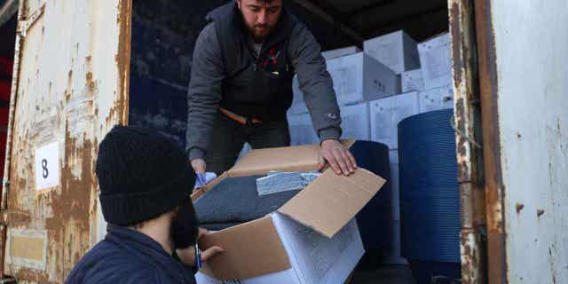 Border customs officials inspect a truck loaded with United Nations humanitarian aid for Syria following a devastating earthquake at the Bab al-Hawa border crossing with Turkey, on Feb. 10, 2023. A U.N. commission claims the international community and the Syrian government did not act quickly last month to help people in need in the northwest of Syria during the first days after the earthquake hit.