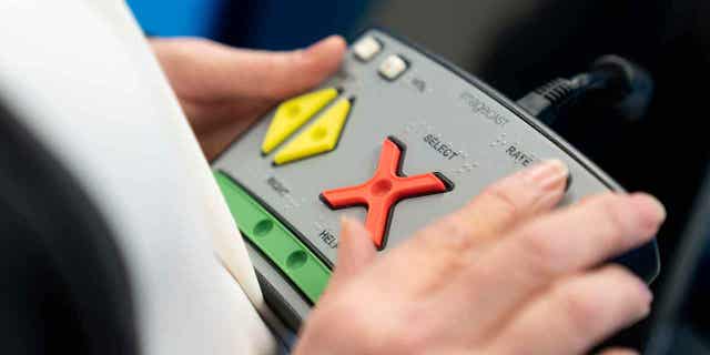 Blind voter uses braille machine in election