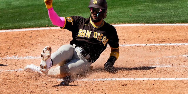 Fernando Tatis Jr., de los Padres de San Diego, anota con un hit de Matt Carpenter en la tercera entrada de un juego de béisbol de entrenamiento de primavera contra los Angelinos de Los Ángeles, el viernes 24 de marzo de 2023, en Tempe, Arizona. 