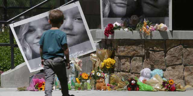 A boy looks at a memorial for Tylee Ryan and Joshua "JJ" Vallow in Rexburg, Idaho, on June 11, 2020. The jury selection is set to begin in the trial of the mother who allegedly killed the two children.