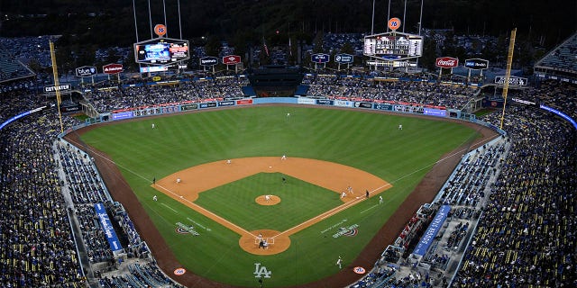 Fans watch at the Los Angeles Dodgers play the Arizona Diamondbacks in the first inning of an opening day baseball game Thursday, March 30, 2023, in Los Angeles. 