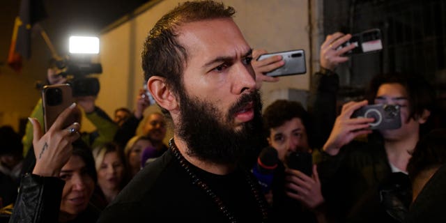 Young fans and media surround Andrew Tate as he leaves a police detention facility in Bucharest, Romania, after his release from prison on Friday March 31, 2023. An official on Friday said Tate, the divisive internet personality who has spent months in a Romanian jail on suspicion of organized crime and human trafficking, has won an appeal to replace his detention with house arrest.