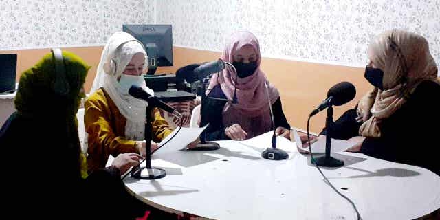Najia Sorosh head of Sadai Banowan a women-run radio station, right, speaks with her Staff in the broadcasting studio in Badakhshan province, Afghanistan, on Mar. 7, 2023.