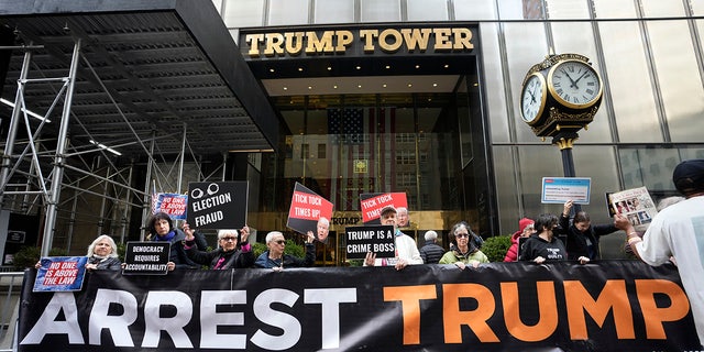 Protesters gather outside Trump Tower on Friday, March 31, 2023, in New York. Former President Donald Trump is expected to return on Monday. 