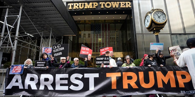 Protesters gather outside Trump Tower on Friday, March 31, 2023, in New York. Former President Donald Trump is expected to return on Monday. 