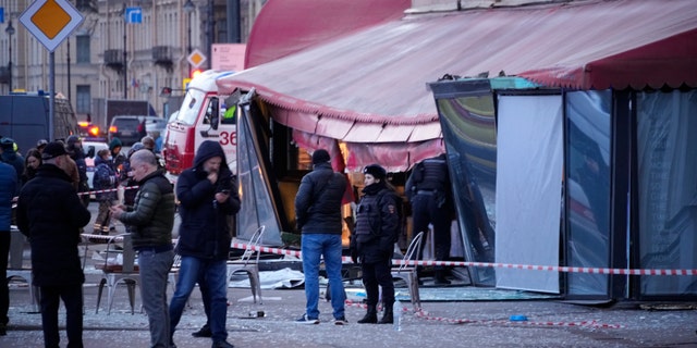 Russian officials are investigating the scene after a pro-Russian military blogger was killed in a cafe explosion that appeared to be an assassination.