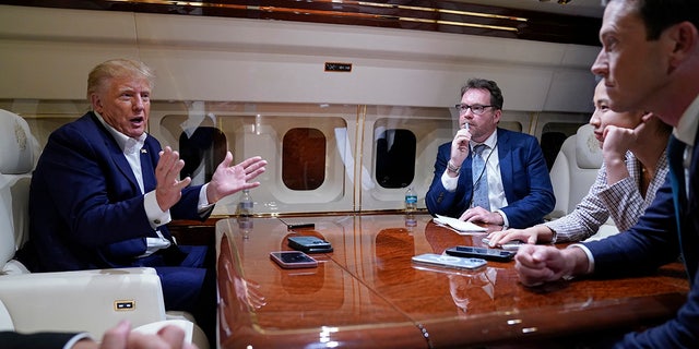 Former President Trump spoke with reporters while in flight on his plane after a campaign rally in Waco, Texas, on March 25, 2023. Trump is expected to fly from Palm Beach, Florida, to New York Monday ahead of a court appearance.
