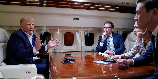 Former President Trump spoke with reporters while in flight on his plane after a campaign rally in Waco, Texas, on March 25, 2023. Trump is expected to fly from Palm Beach, Florida, to New York Monday ahead of a court appearance.